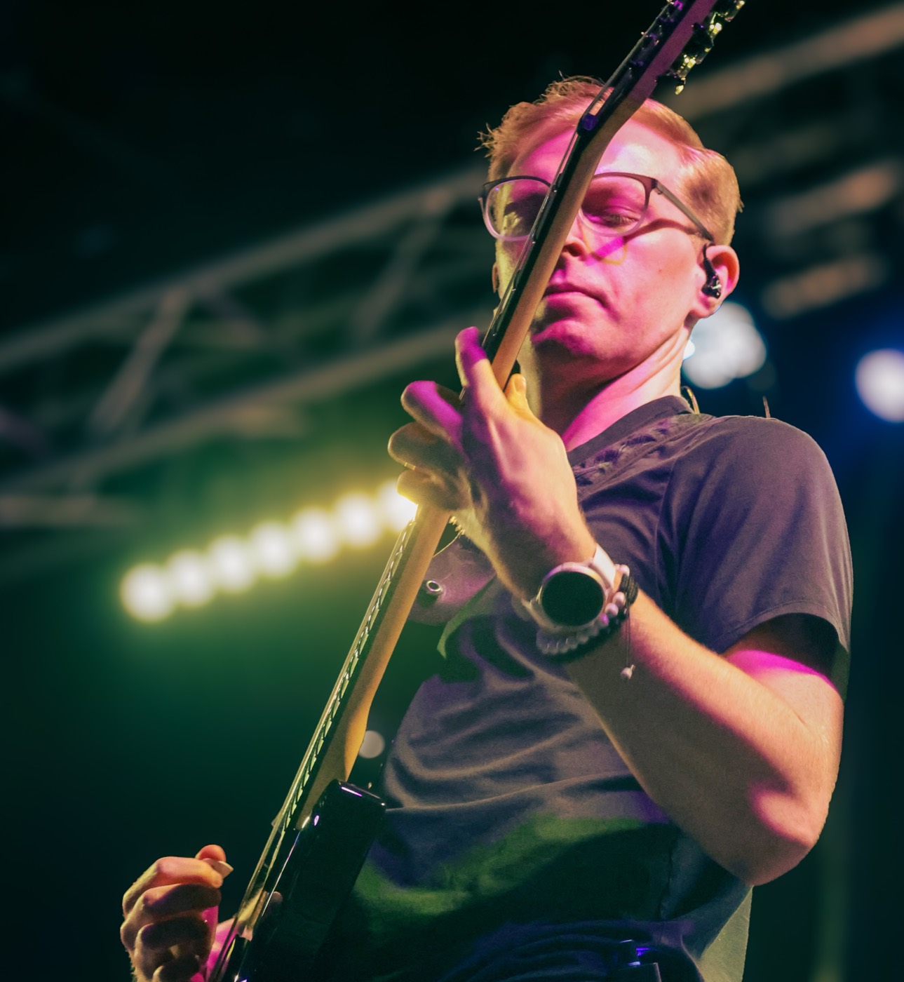 Gage DeZoort playing bass under stage lights